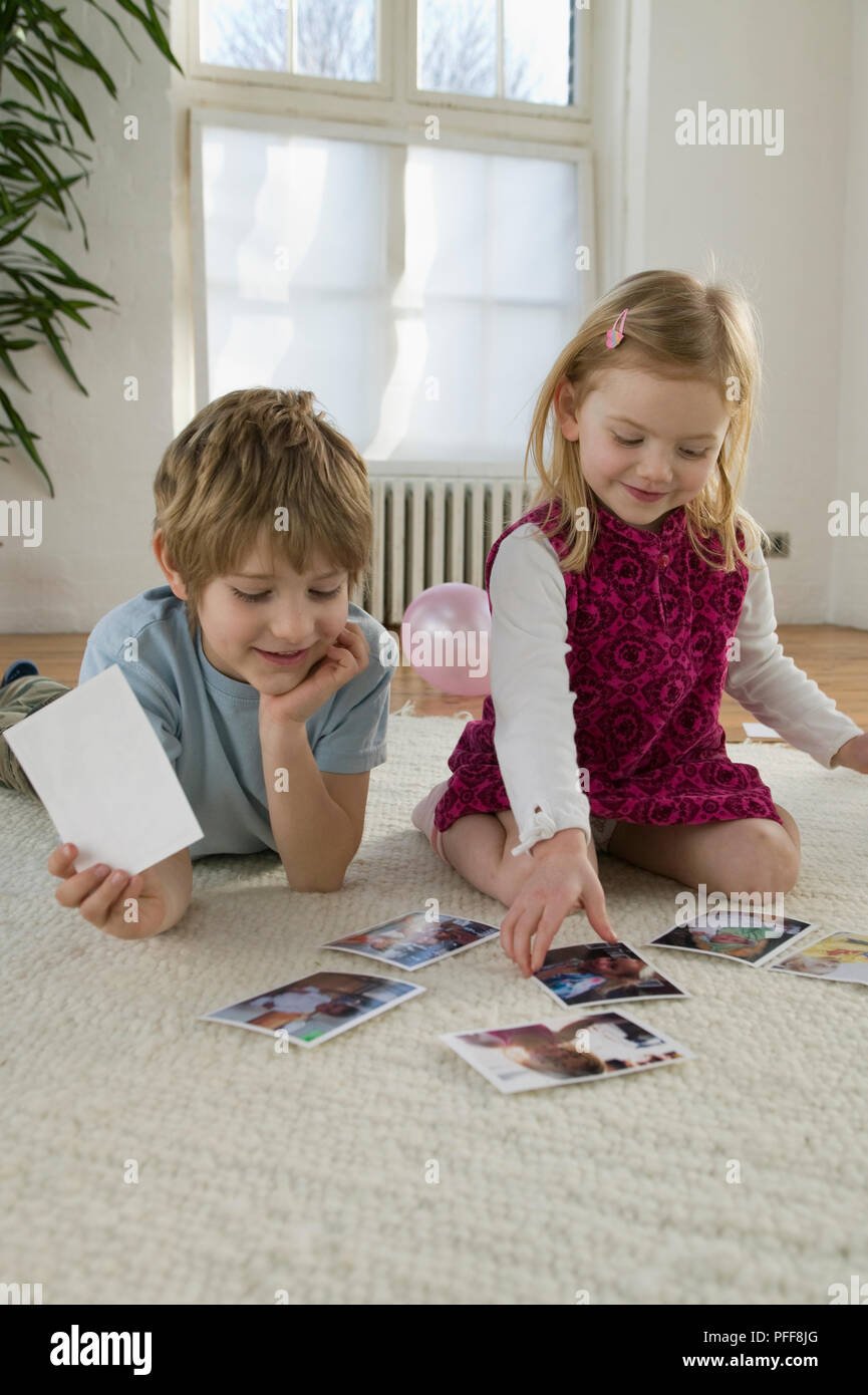 Boy and girl looking at photos, smiling Stock Photo - Alamy
