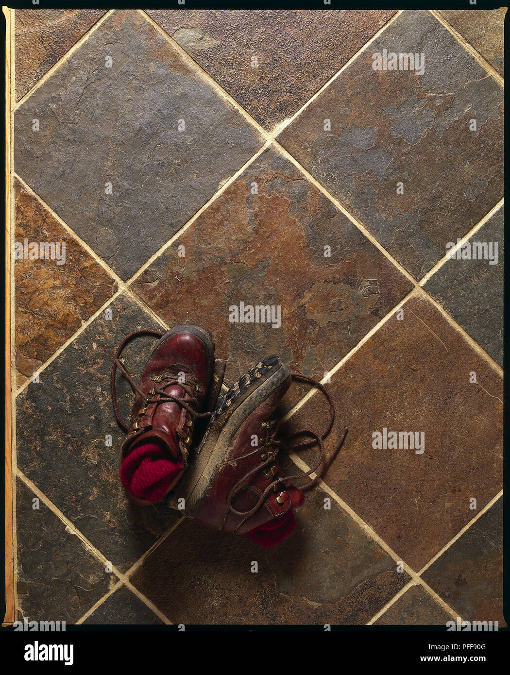 Dirty Hiking Boots on Slate Kitchen Floor Stock Photo