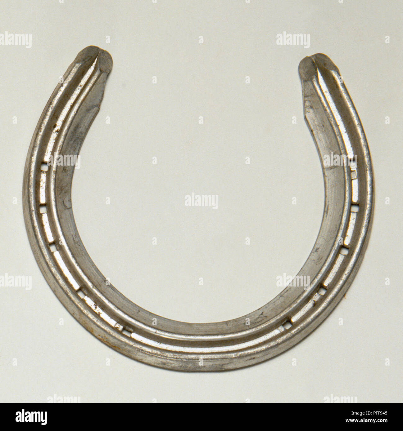 Racing Plate, lightweight aluminium horseshoe for racehorses, nail holes, above view Stock Photo