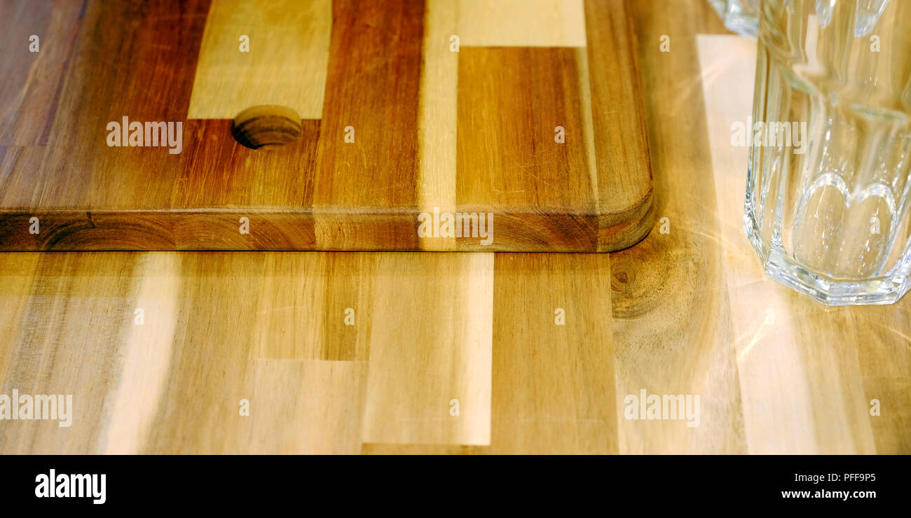 Set Of Brown Cutting Board For Kitchen Located On A Shelf Against The