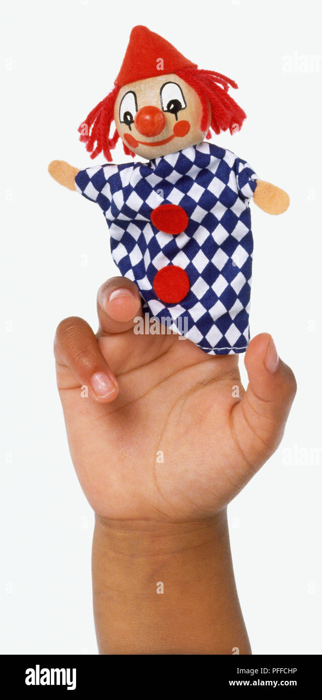Clown finger puppet on childs hand, front view. Stock Photo