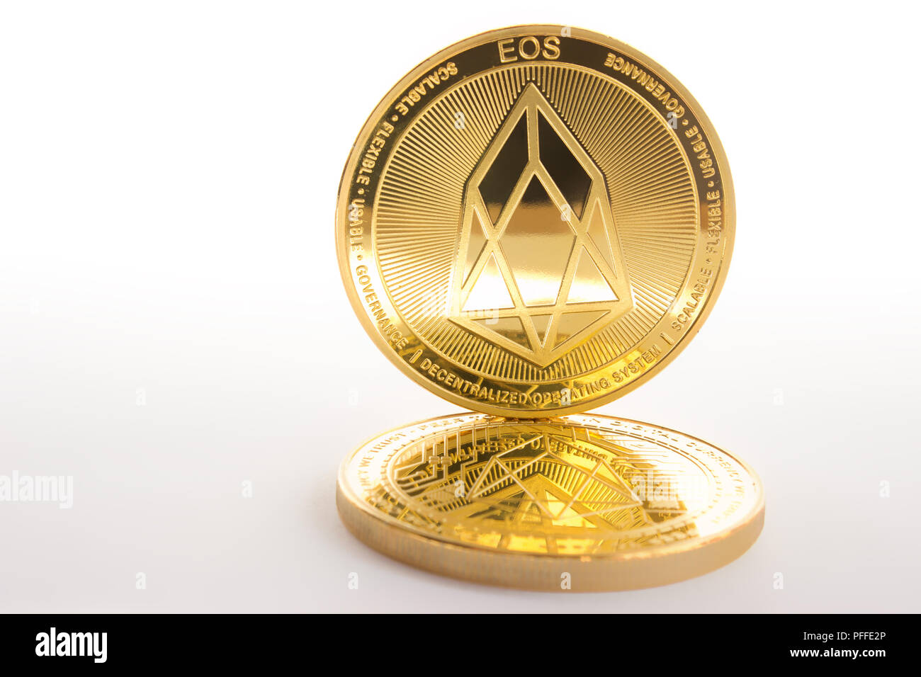 On a white background are coins of a digital crypto currencies - eos. In  addition to the lying coin, there is standing eos - shadow Stock Photo -  Alamy