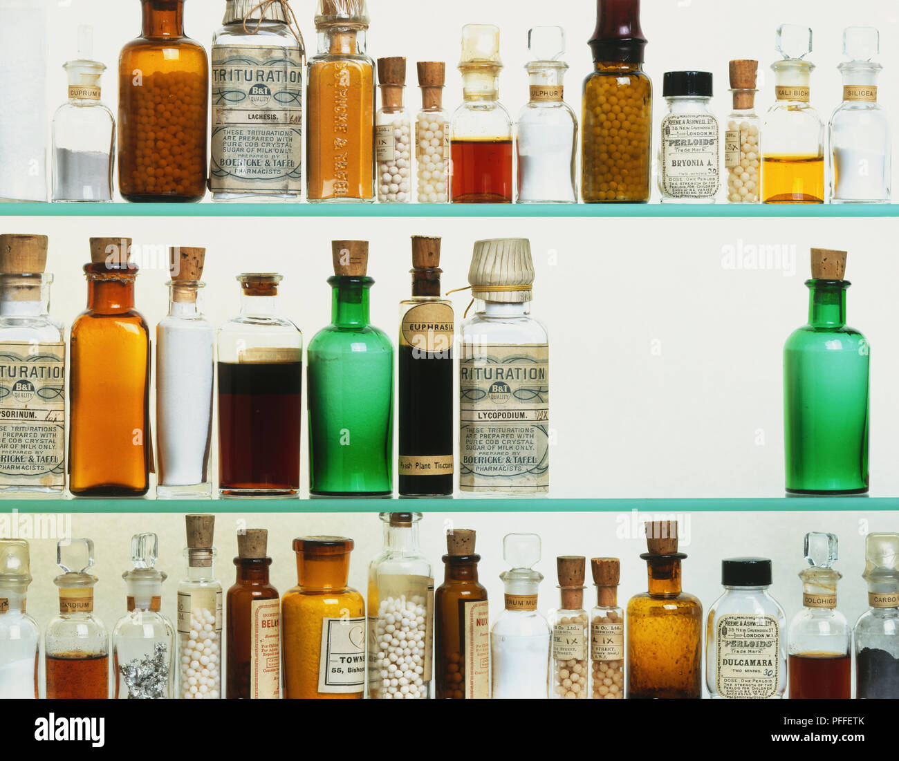 Bottles of homeopathic medicine on glass shelves Stock Photo - Alamy