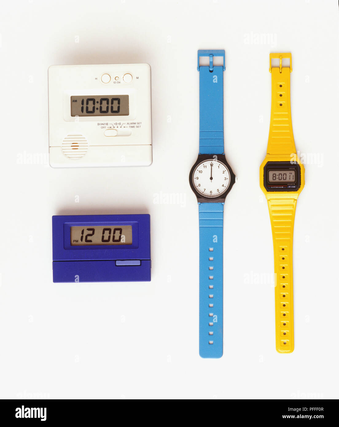 Two digital clocks, digital and analogue wristwatches, close up Stock