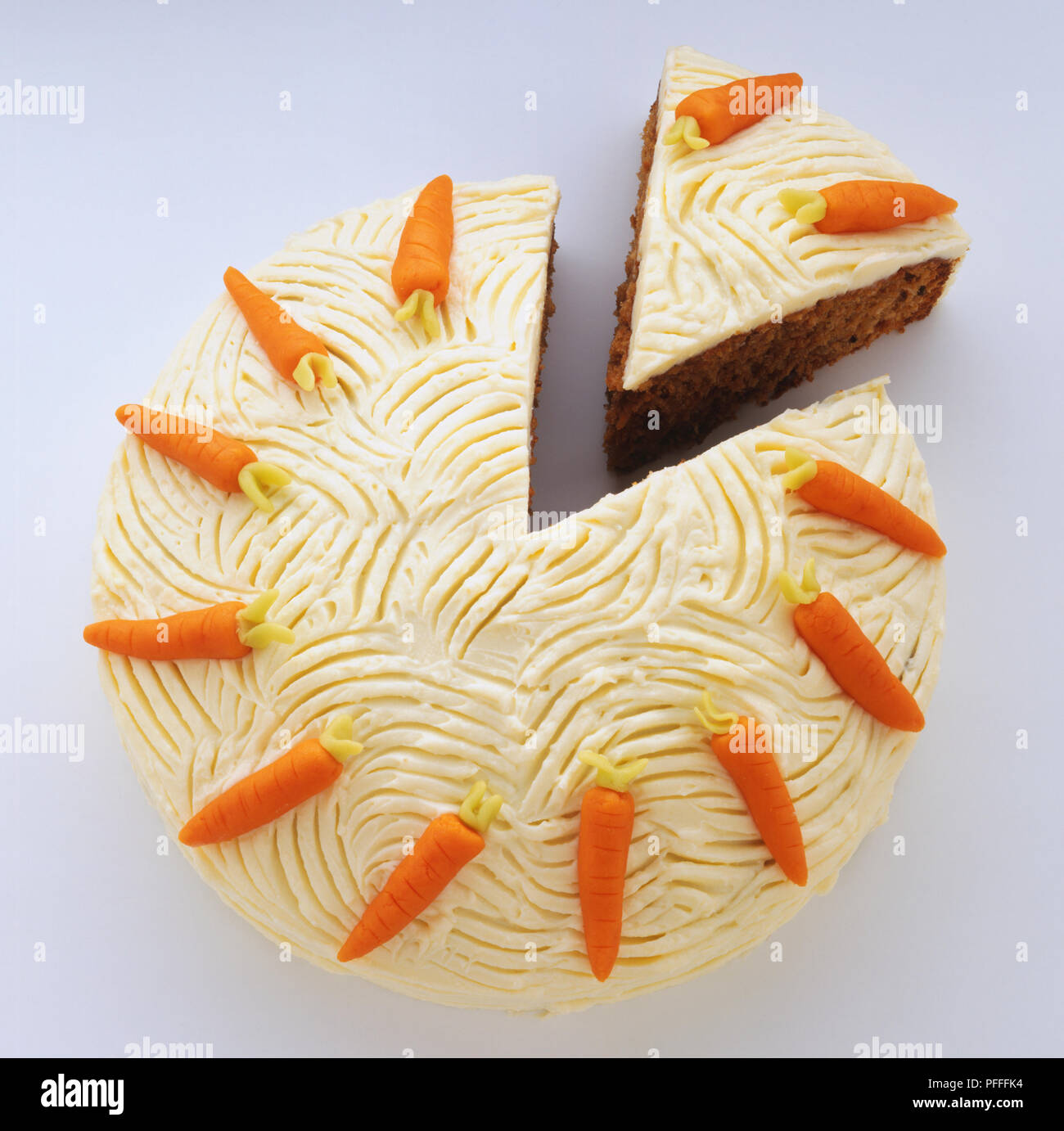 Iced Carrot Cake With Decorations Of Marzipan Carrots With A Slice