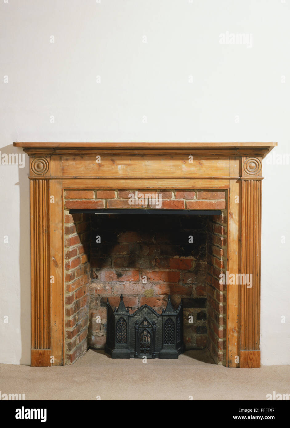 Red Brick Fireplace With A Wooden Frame And Mantlepiece Front