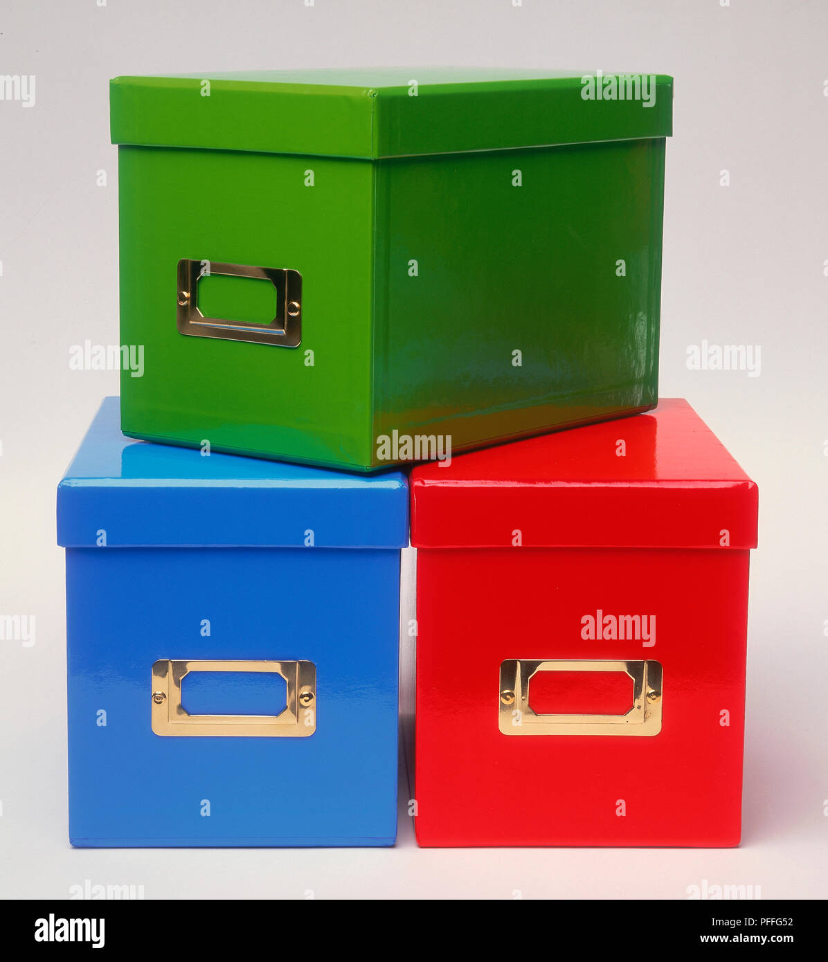 Three brightlycoloured cardboard storage boxes, stacked on top of one