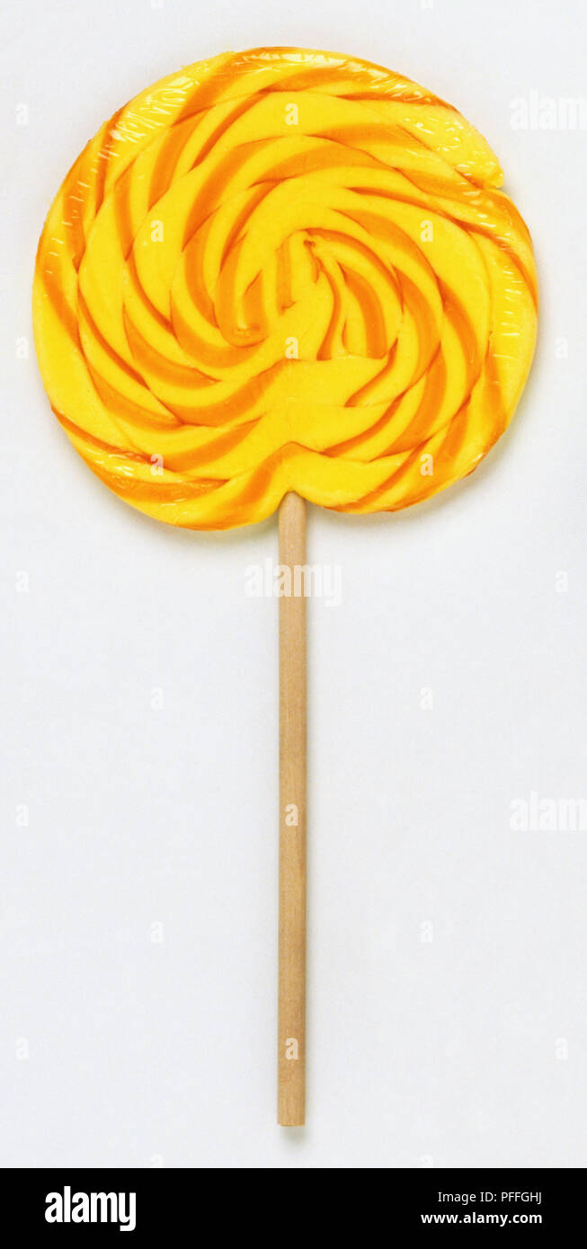 Orange and yellow swirl lollipop, close up Stock Photo