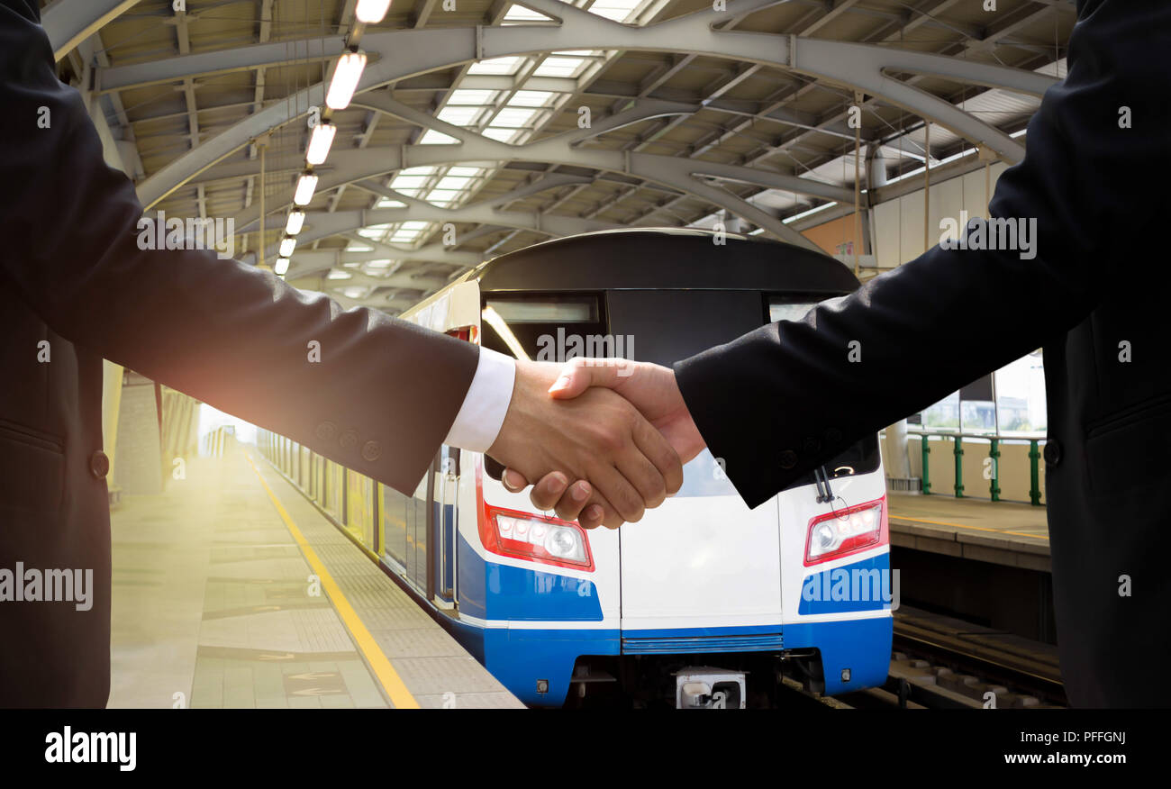 Businessman han dshake agreement with public transport sky train Stock Photo