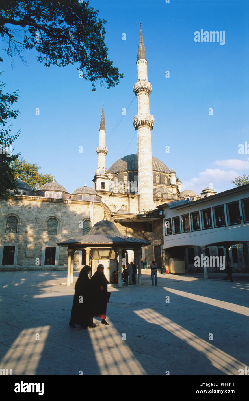 Asia, Turkey, Istanbul, exterior of the Eyup Mosque, Istanbul's holiest mosque, standing beside the tomb of Eyup Ensari, a companion of the Prophet Mohammed, large central dome and tall minarets, blue sky behind. Stock Photo
