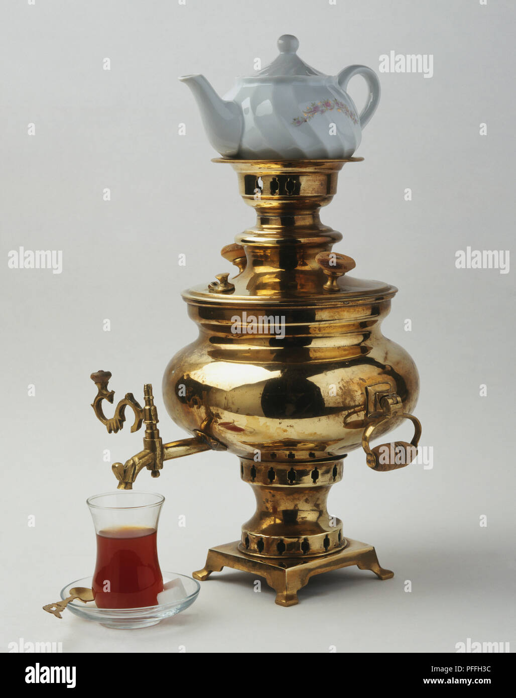 Traditional brass samovar for making Turkish tea, ceramic teapot on top