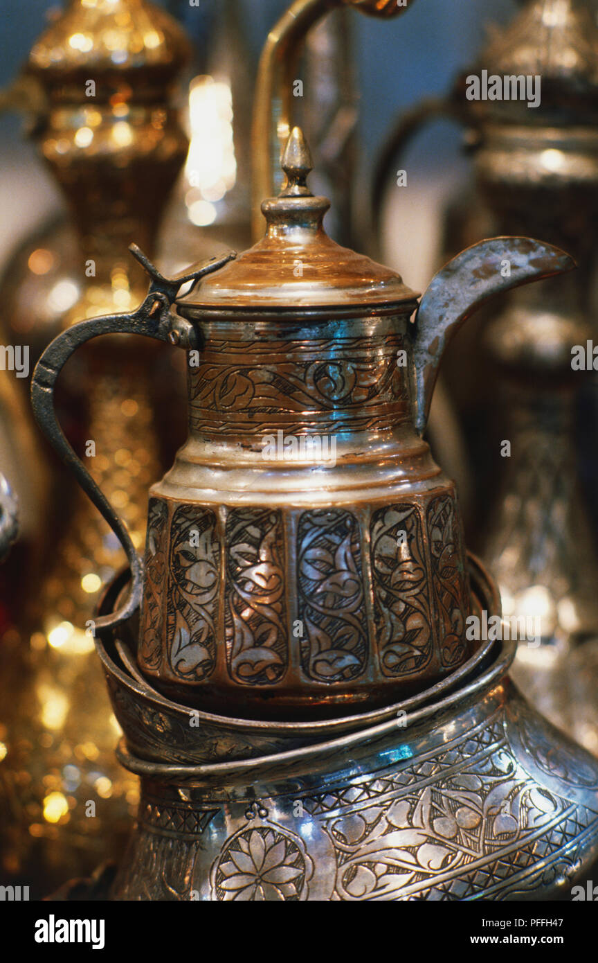 Asia, Turkey, Istanbul, Grand Bazaar, brass coffee pot with decorative patter, sitting on other brass items, on sale. Stock Photo
