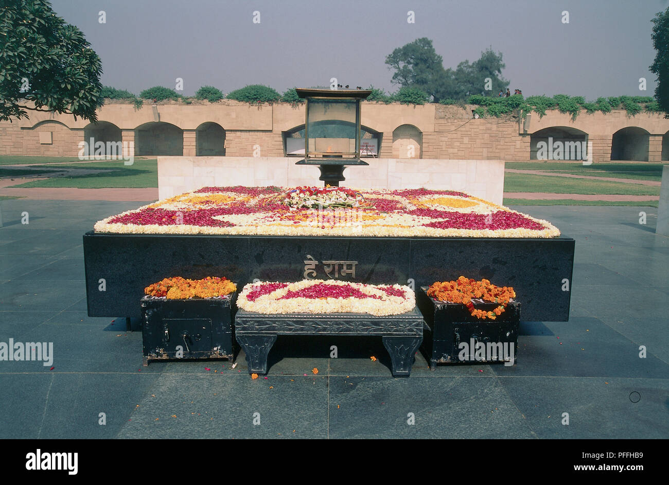 Gandhi Samadhi, Rajghat, the sight of Gandhi's cremation, black granite platform inscribed with his last words, garlands of orange marigolds adorning memorial. Stock Photo