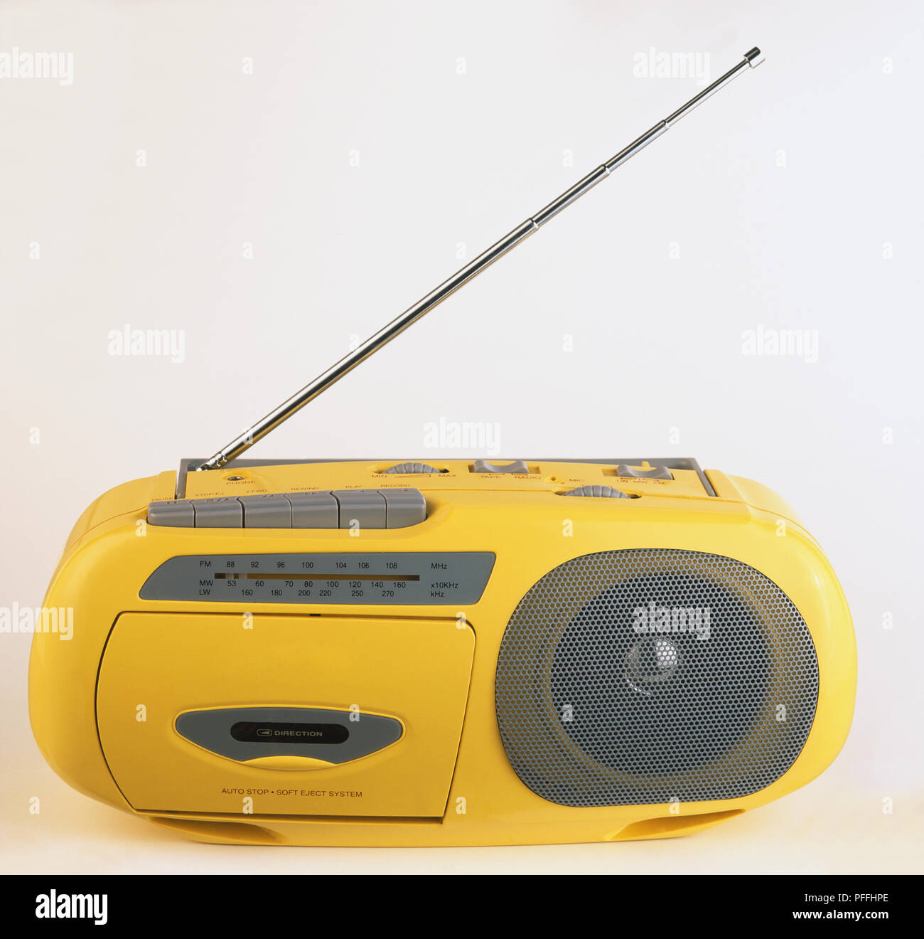 Chunky, yellow Daewoo radio cassette recorder with half raised receiver. Stock Photo