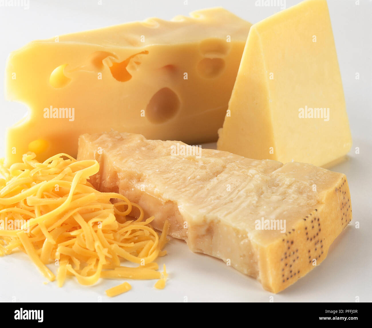 Three types of hard cheese, Emmental, Parmesan and Cheddar cheese with