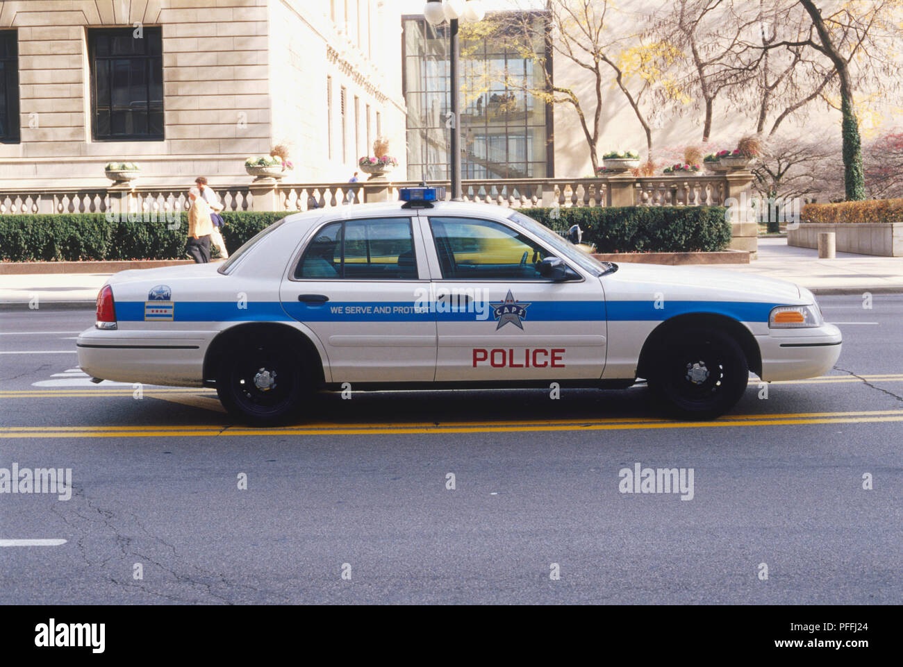 USA, Illinois, Chicago, police car driving along street, side view