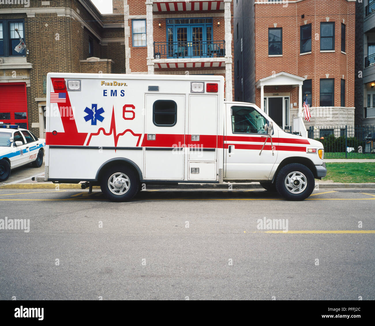 USA, Illinois, Chicago, emergency ambulance parked by curb, next to police car. Stock Photo