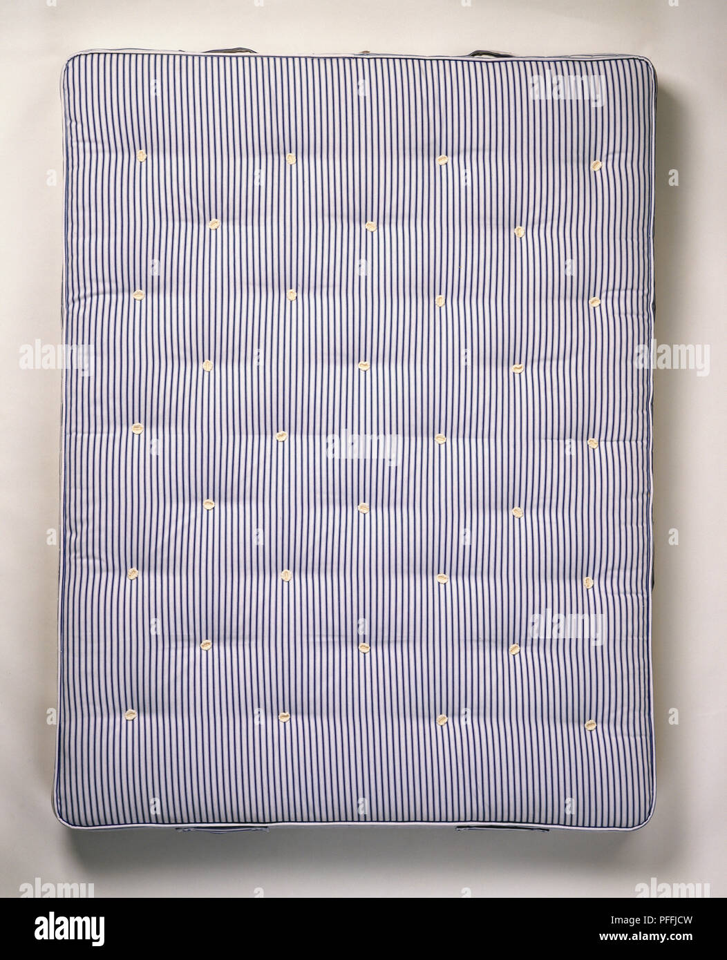Hand-tufted, open-spring, firm double mattress, above view. Stock Photo