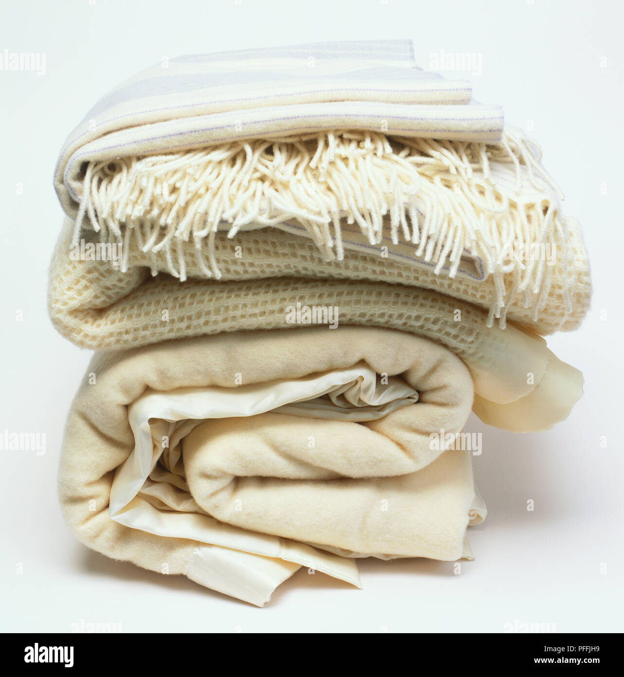 Pile of folded wool blankets and throws, side view Stock Photo
