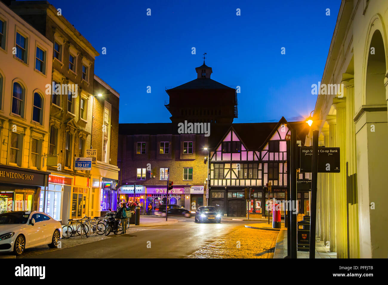 TOP OF THE HIGH STREET IN COLCHESTER, ESSEX, AT NIGHT AND SHOWING JUMBO WATER TOWER Stock Photo