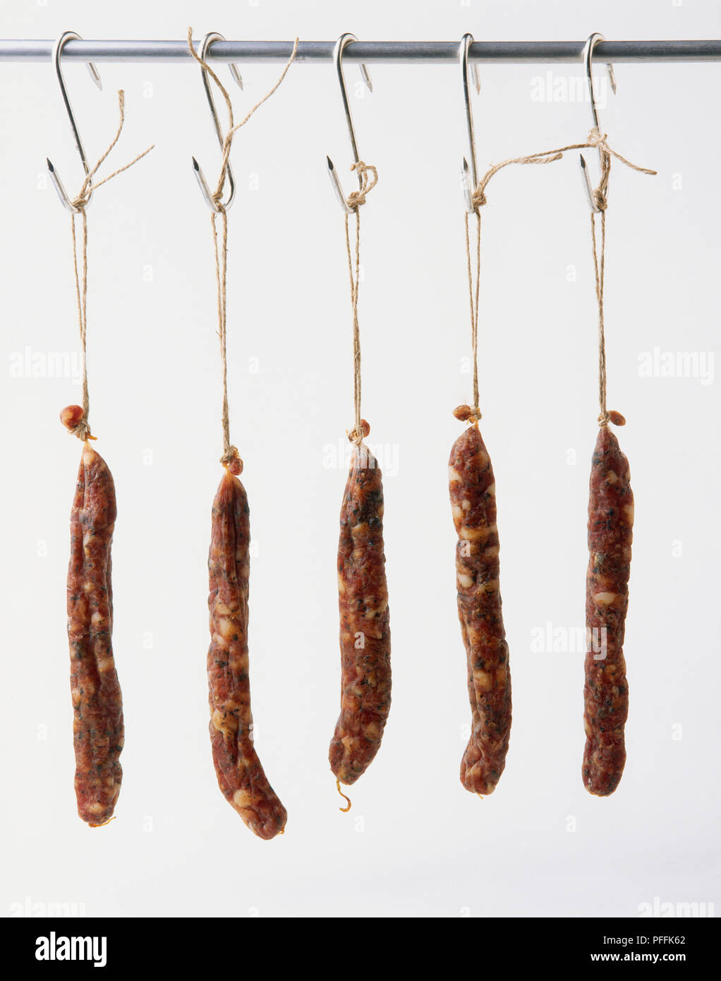 Dried salami hanging on hooks Stock Photo Alamy