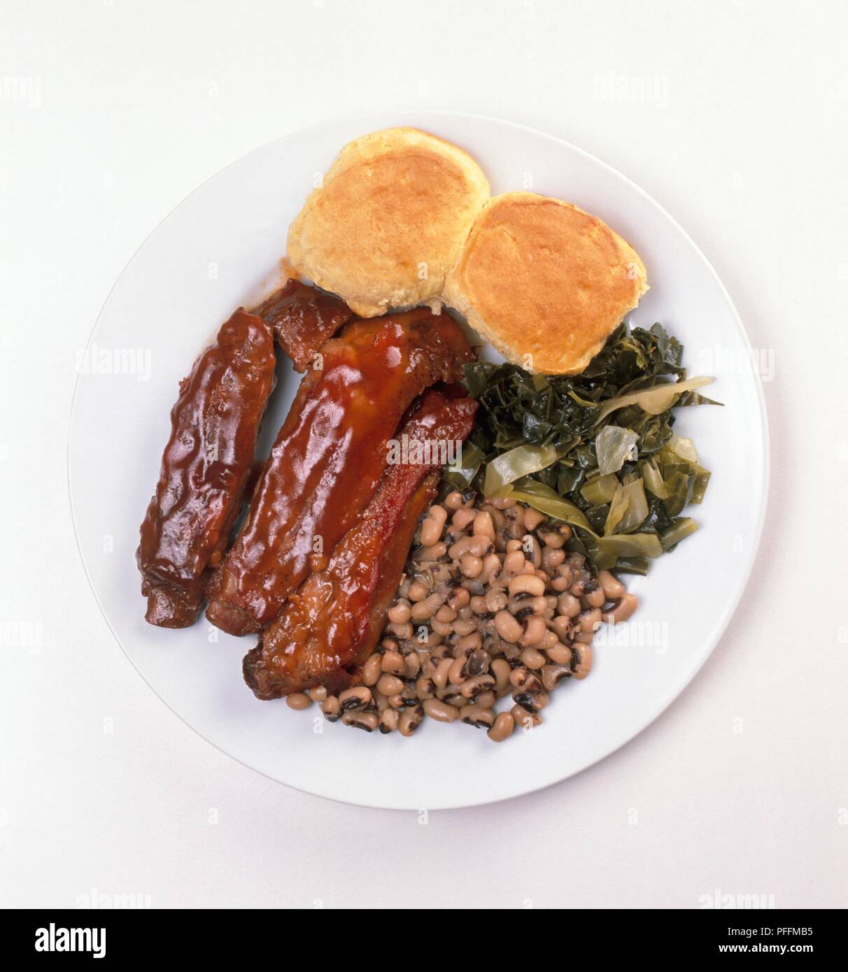 Barbecued pork ribs, corn bread muffins, collard greens, and blackeyed