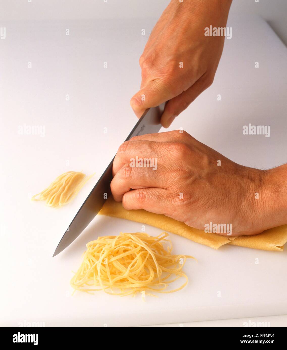 Using kitchen knife to cut capelli d'angelo pasta dough Stock Photo Alamy