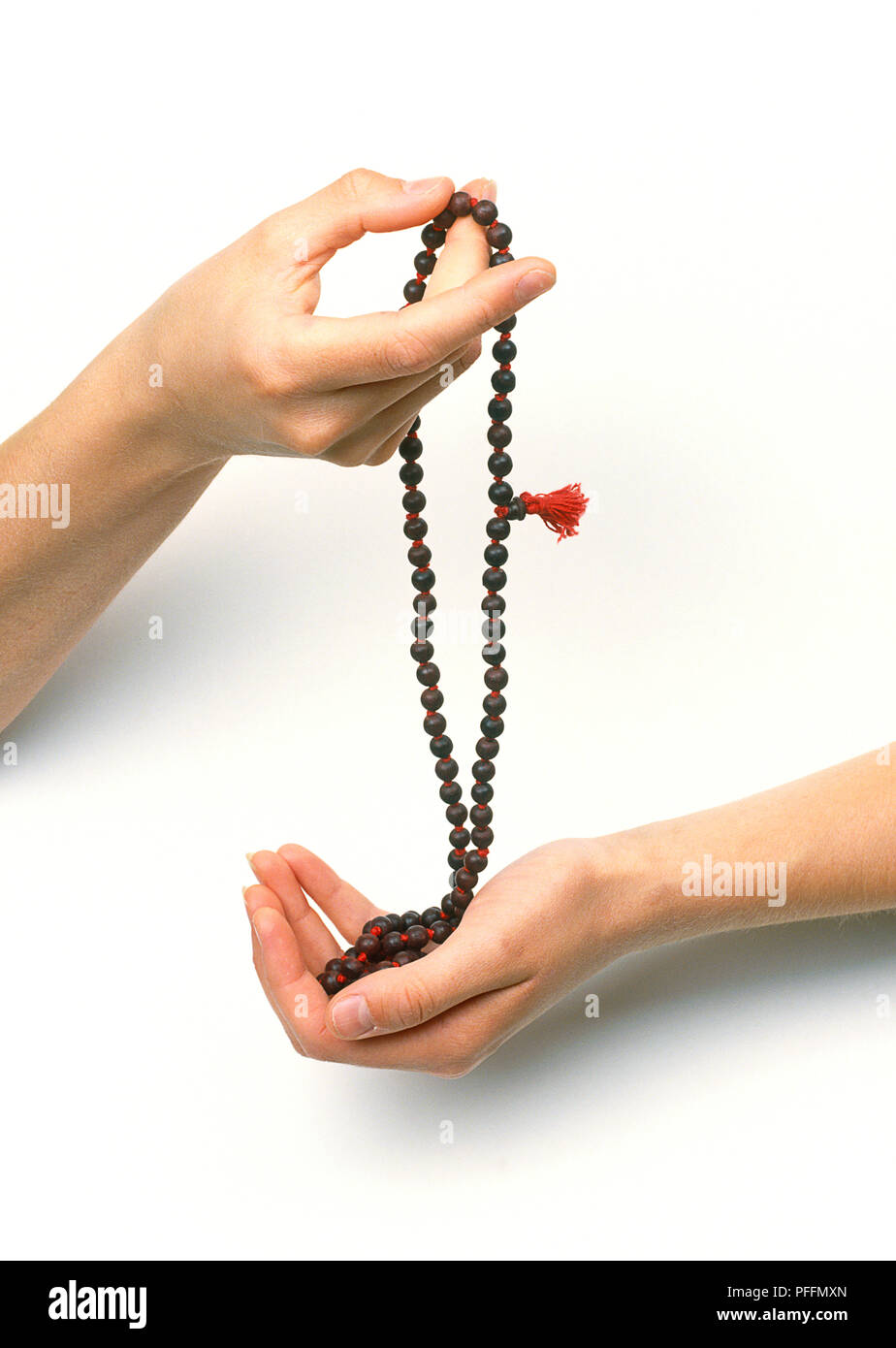 Japa Mala beads, one person holding one end and another person