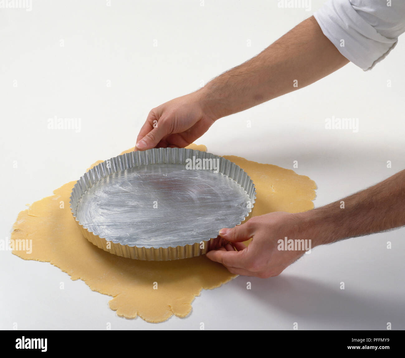 Lining tart tin, placing tin on top of rolled out dough to check the