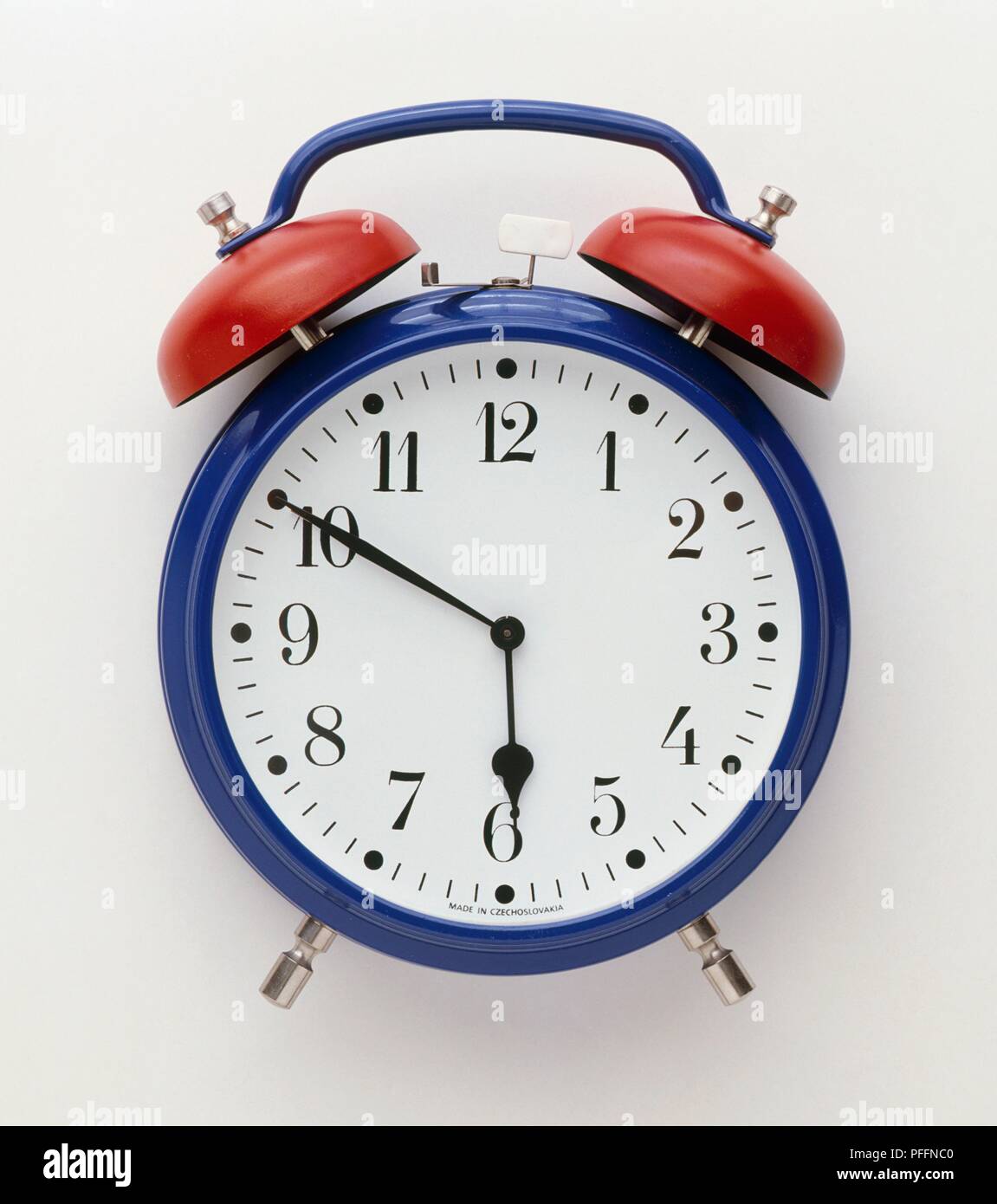 A blue and red alarm clock with bells, front view Stock Photo Alamy