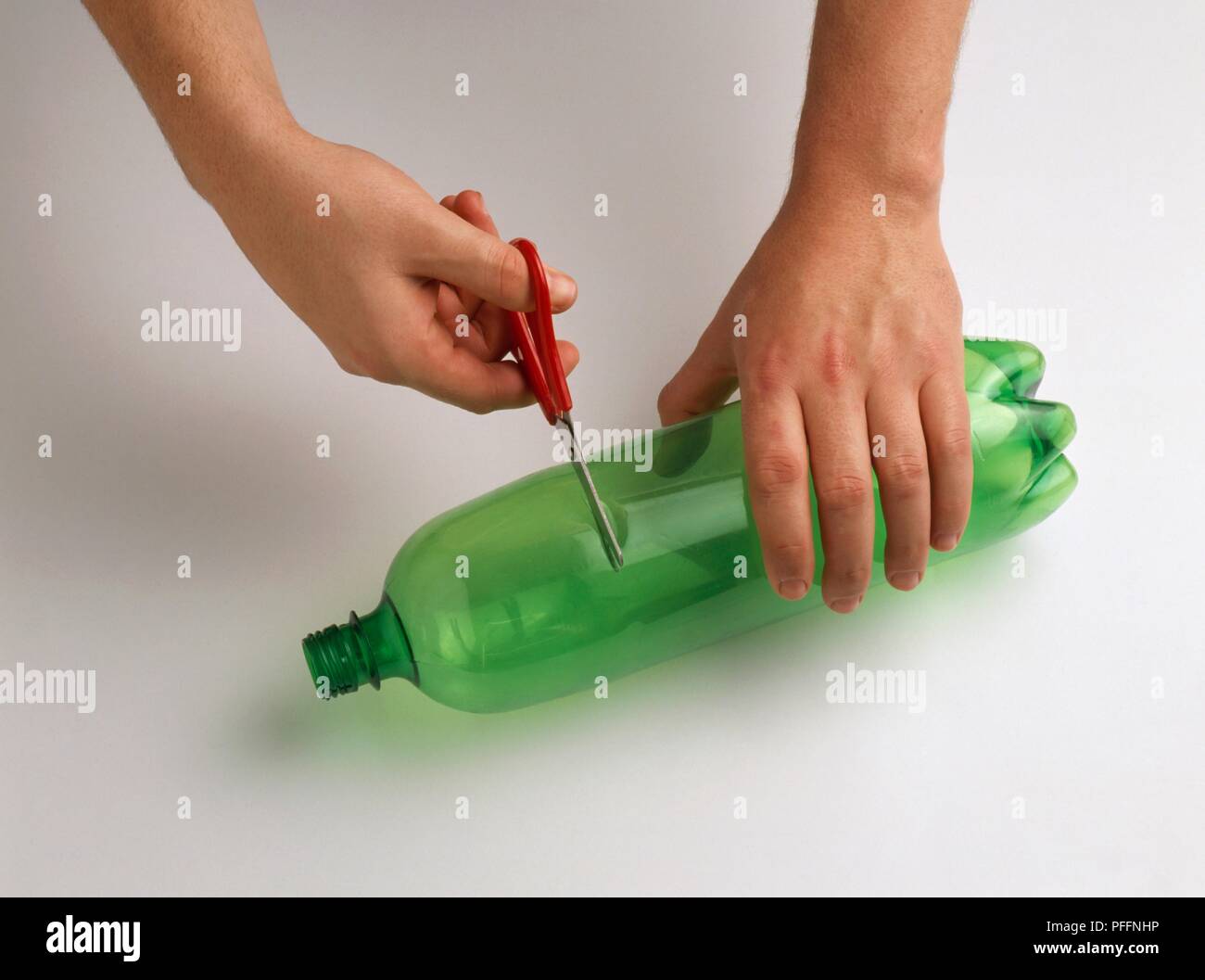 Plastic bottle being cut open with scissors Stock Photo Alamy