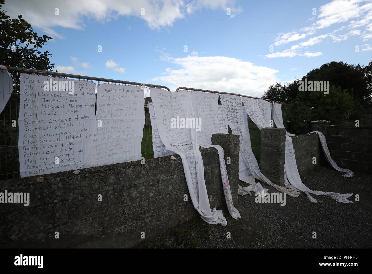 Hotel bed sheets with the names of hundreds of dead children draped on the gates of a mass burial site at Tuam, Co Galway where a vigil will take place during the Pope's visit to Knock Shrine in Co Mayo. Stock Photo