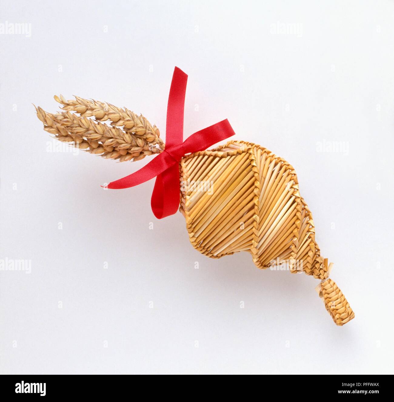 Corn dolly with red ribbon Stock Photo