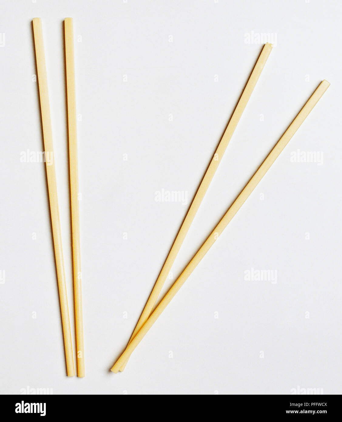 Two sets of plain wooden chopsticks Stock Photo