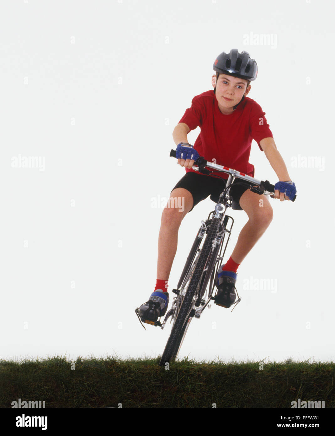 Child cycling on grass, front view Stock Photo Alamy
