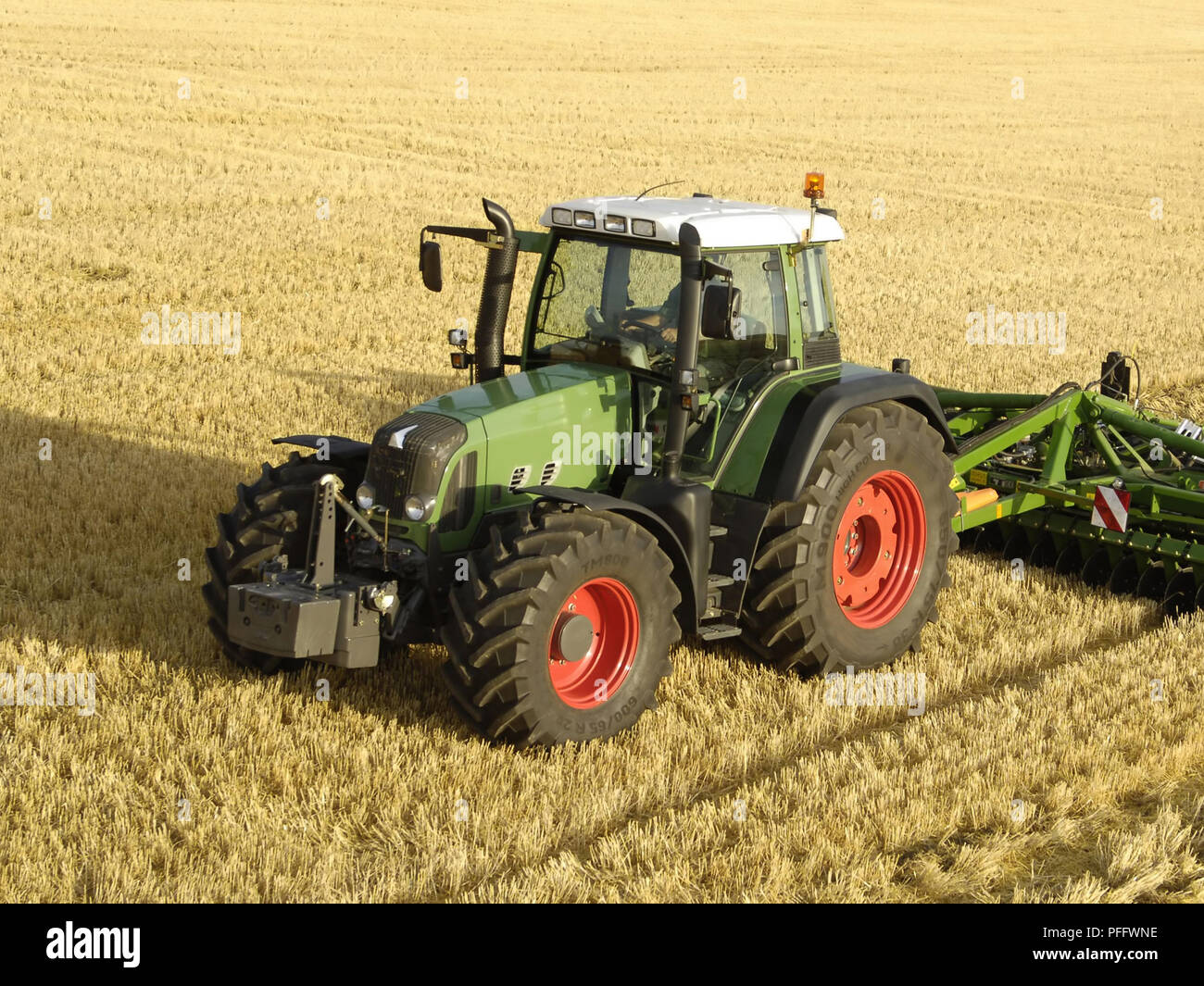 farmer on a tractor is harvesting Stock Photo - Alamy