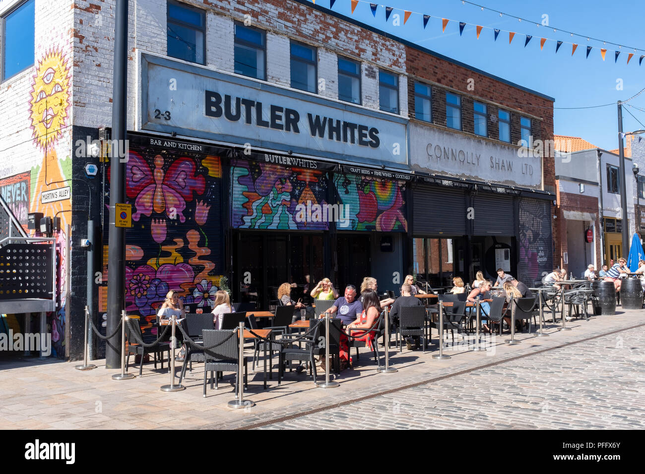 Image of Kingston Upon Hull UK City of Culture 2017. Shown in the fruit market region is Butler Whites people enjoying a drink outside in the sun. Stock Photo