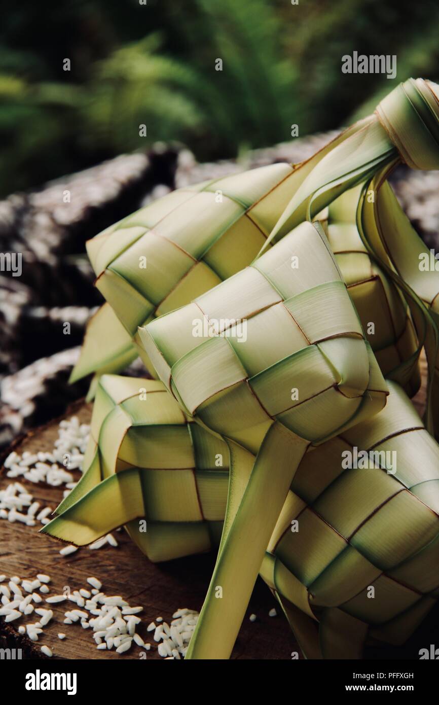 Ketupat, the traditional diamond-shaped rice cake in casing of woven coconut leaf; highly popular during Eid celebrations. Stock Photo