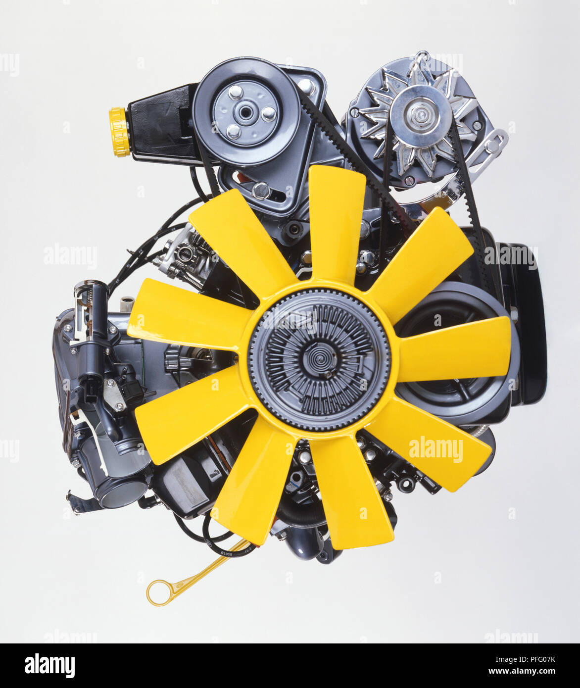 Front view of a V6 12 valve engine with a yellow fan at the front Stock