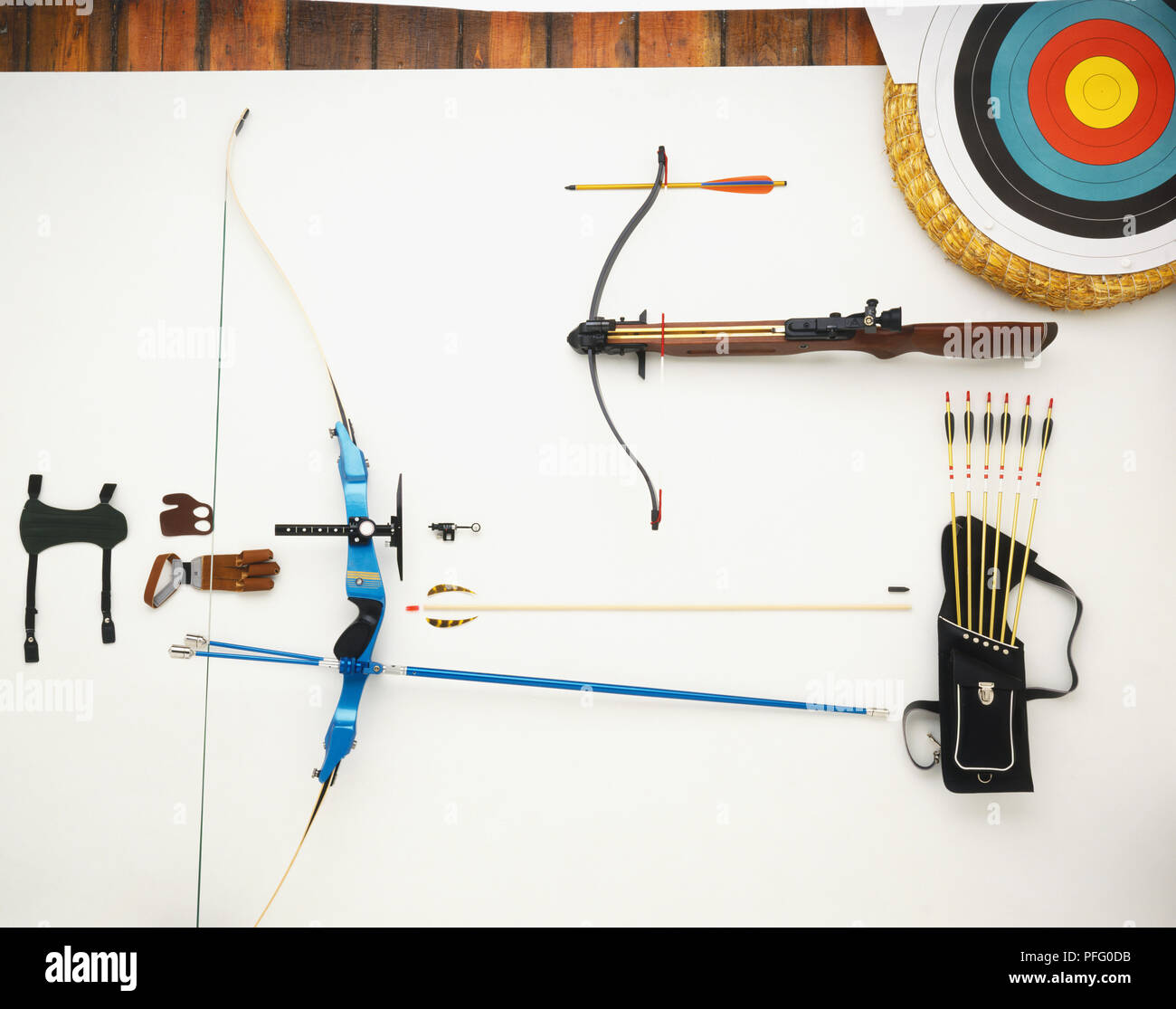 Crossbow, modern bow, archery target, archer's glove, finger tab, bracer and a quiver containing arrows Stock Photo