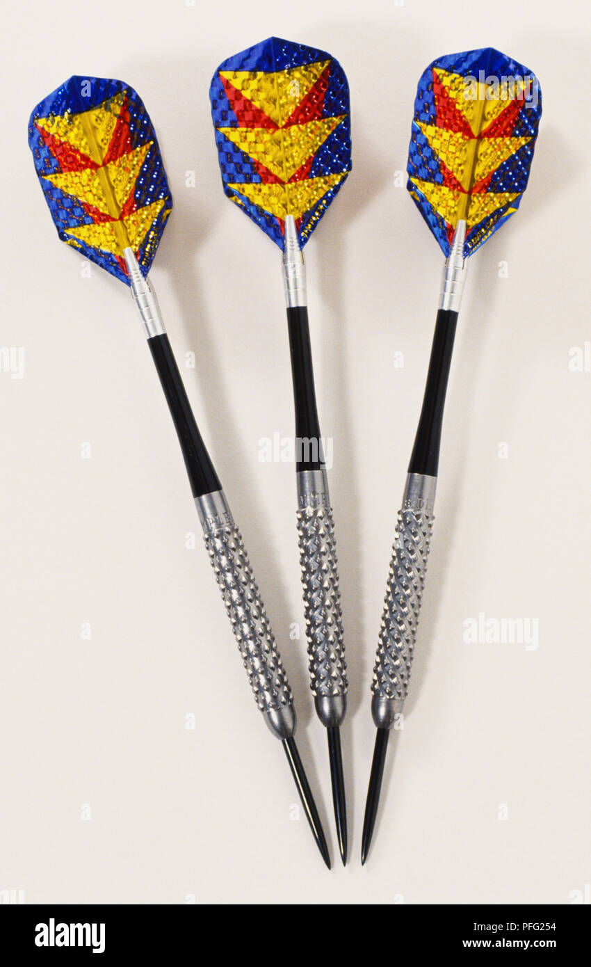 Three weighted metaltipped darts with plastic feathers Stock Photo Alamy