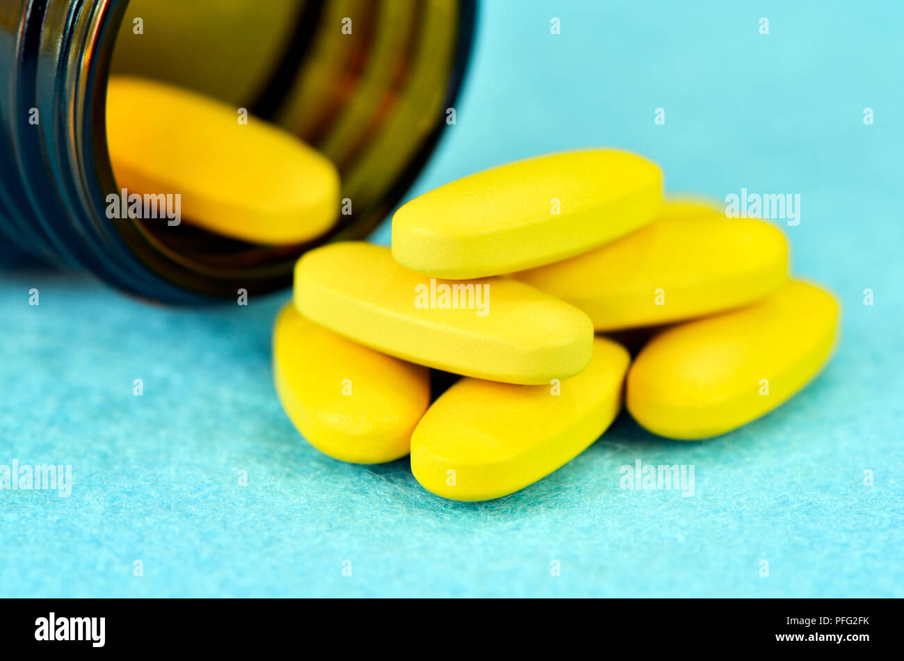 Vitamin C tablet on blue background. High dose vitamin C dietary supplement for immune booster. Stock Photo