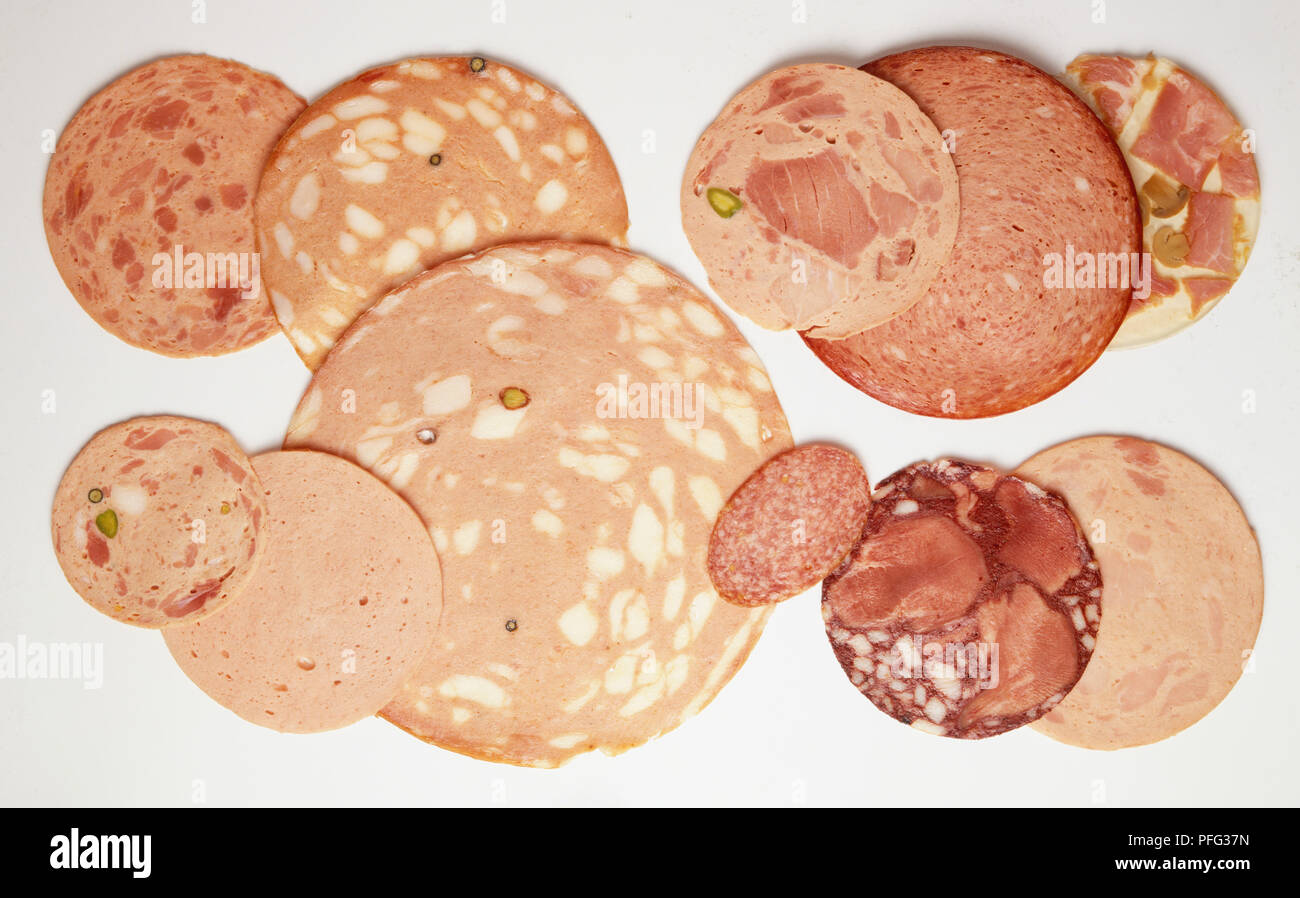 Selection of cooked and lightly smoked sausage slices, close up. Stock Photo