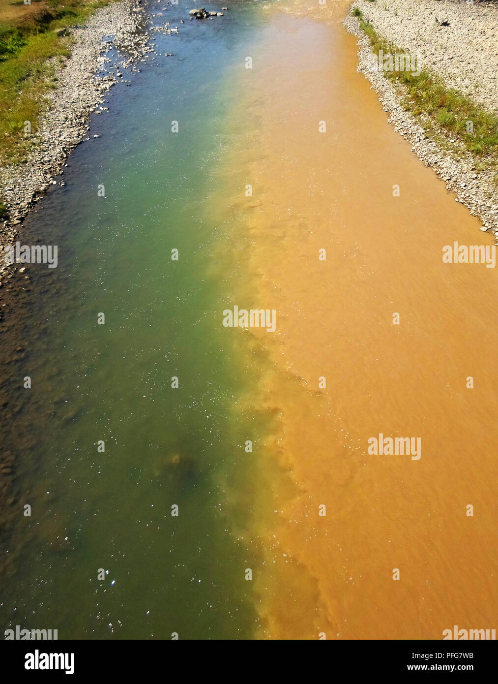 polluted river, half dirty, half clean Stock Photo