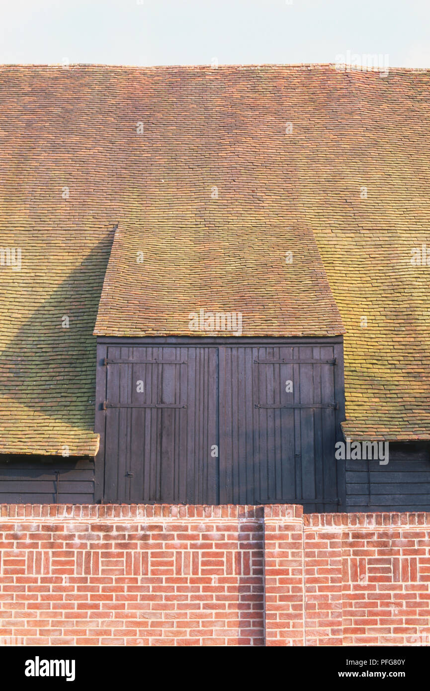Sloping roof and red brick walls, widely used in Tudor times. Stock Photo