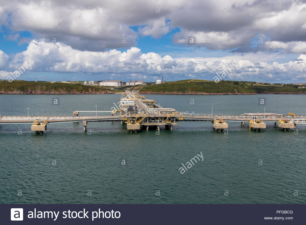South Hook LNG terminals in the waters of Milford Haven, Pembrokeshire with gas storage tanks onshore in the background Stock Photo