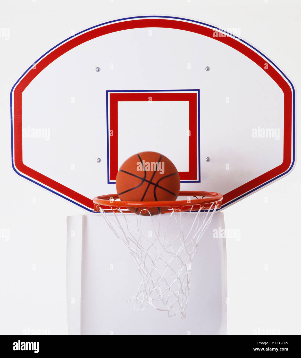 Basketball about to drop into basket. Stock Photo