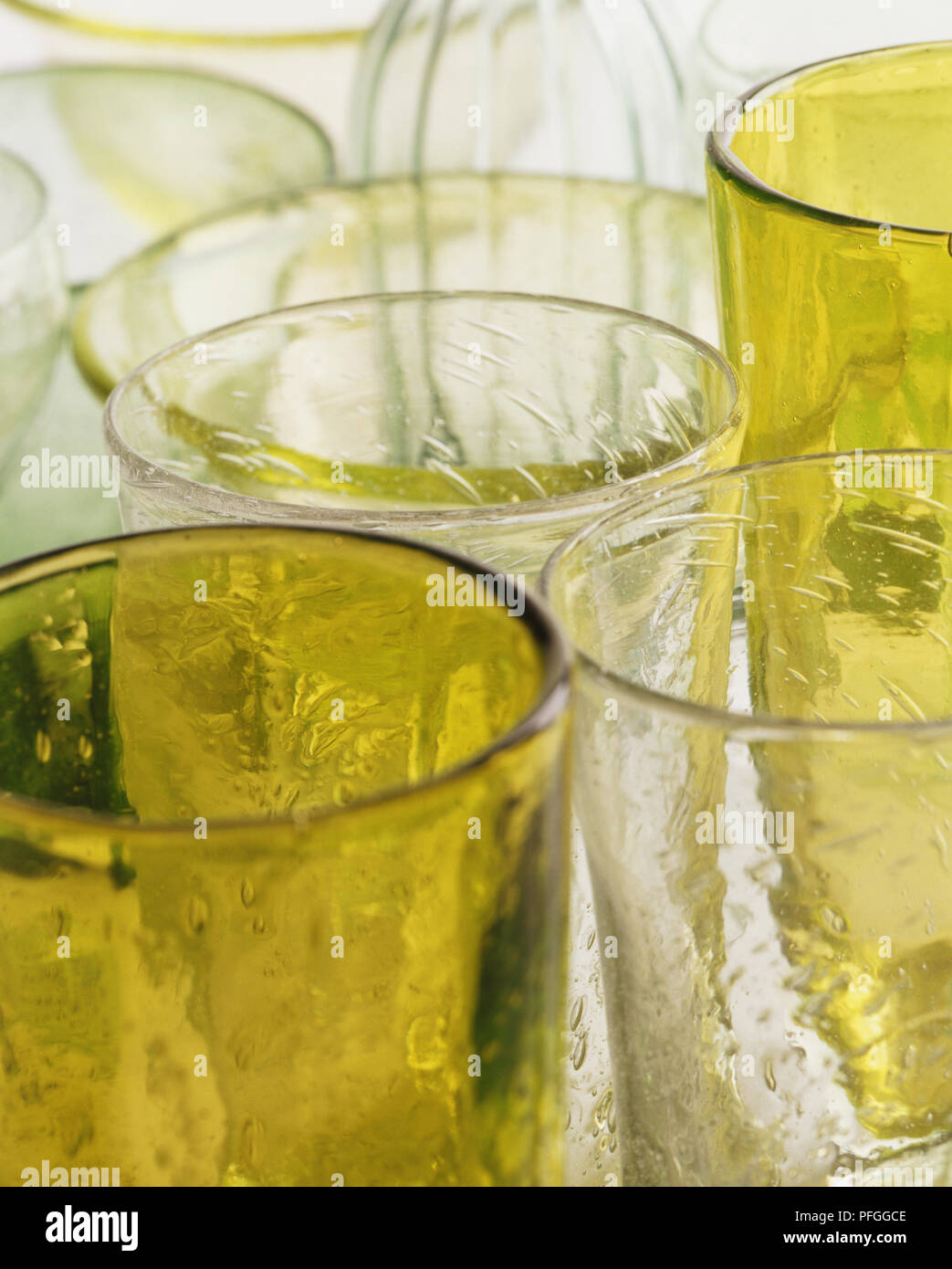 Drinking glasses made from textured white glass and green coloured
