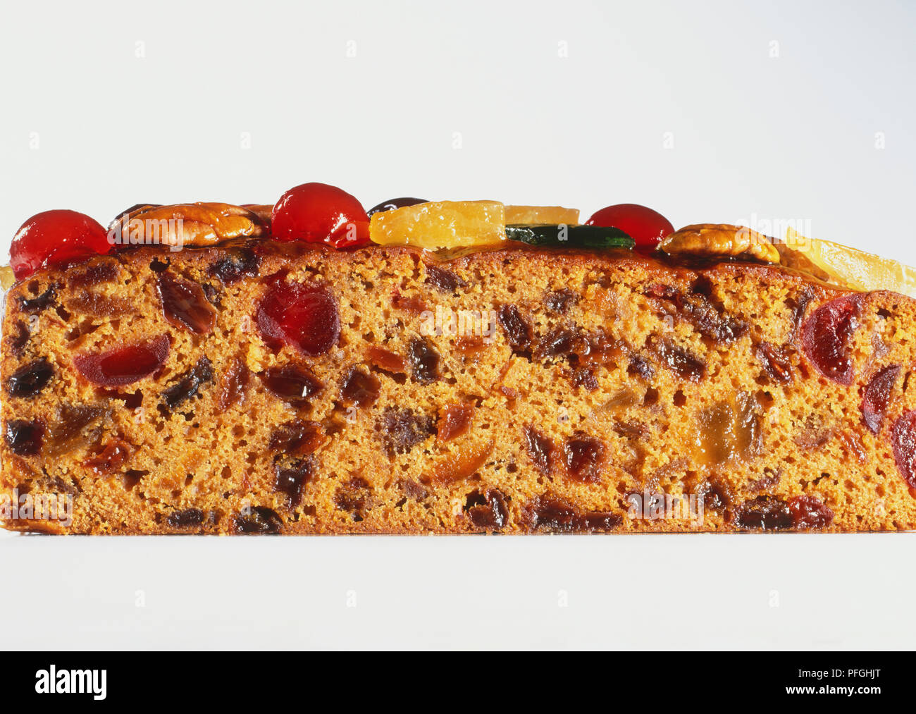 Closeup of brandied fruit cake slice, rich with sultanas, apricots