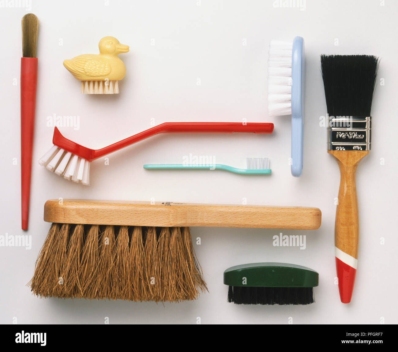 Two nail brushes, two paint brushes, kitchen brush, tooth brush and bristle brush, close up Stock Photo